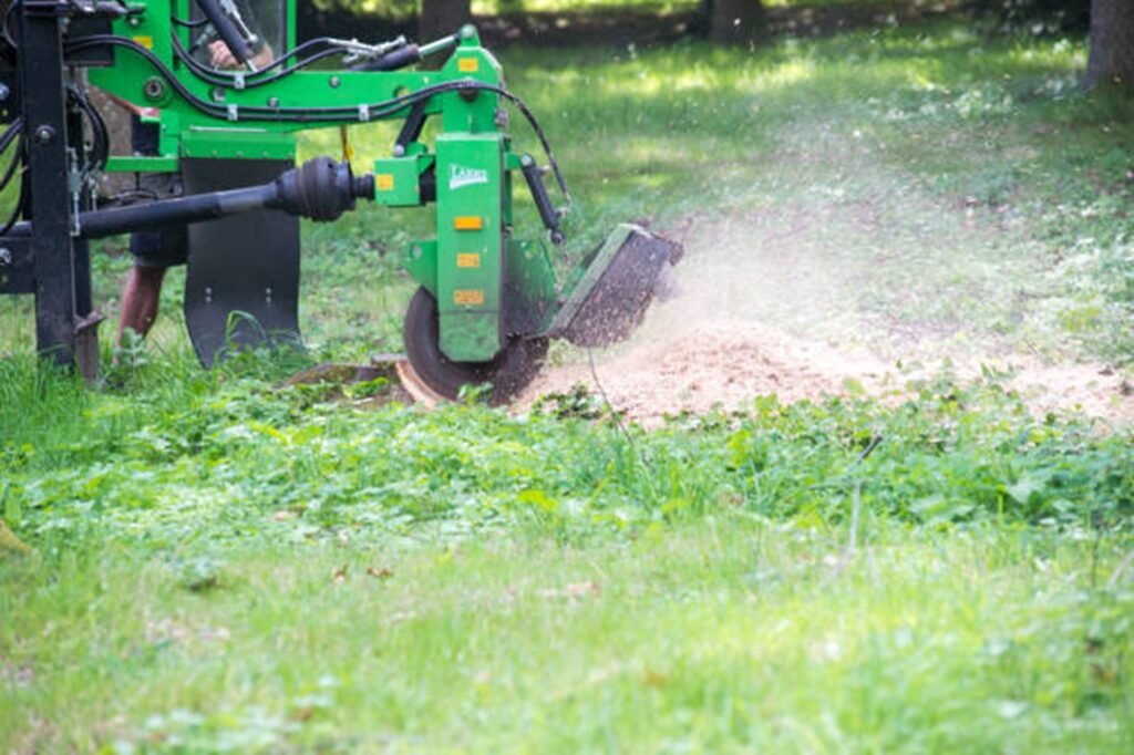 Professional stump grinding machine removing a tree stump below ground level during stump grinding and removal service in Ballwin, MO.